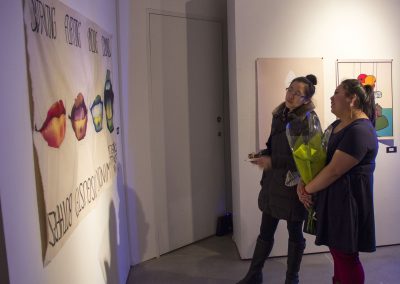 Visitors view the art in the BFA Show Reception at Gallery 7, University of Wisconsin-Madison.