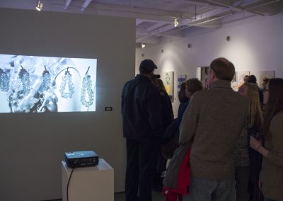 Visitors view the art in the BFA Show Reception at Gallery 7, University of Wisconsin-Madison.