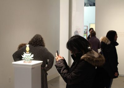 A visitor photographs a metals piece by Matt Mauk at his Master of Arts Exhibition "Hothouse," Art Lofts Gallery, Department of Art University of Wisconsin-Madison