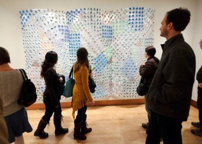 Visitors enjoy the opening reception for the Art Department Faculty Exhibition, being held in temporary exhibition galleries at the Chazen Museum of Art at the University of Wisconsin-Madison. The exhibition features work by 34 current UW-Madison faculty, staff and affiliates. It includes paintings, drawings, sculpture, graphics, ceramics, textiles, woodwork, metalwork, glass, prints and photographs, as well as performance, video and digital art. Pictured here, visitors view a piece by undergraduate advisor Julie Ganser.