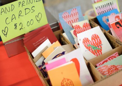 Customers look through hand-printed cards, made by the student organization Fresh Hot Press and on sale at the Mosse Humanities Building at the University of Wisconsin-Madison.