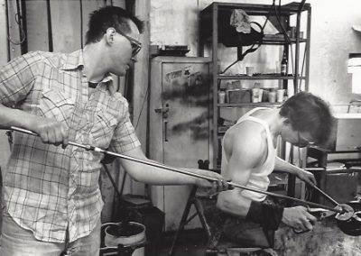 Students work on a blown glass project in the glass lab.