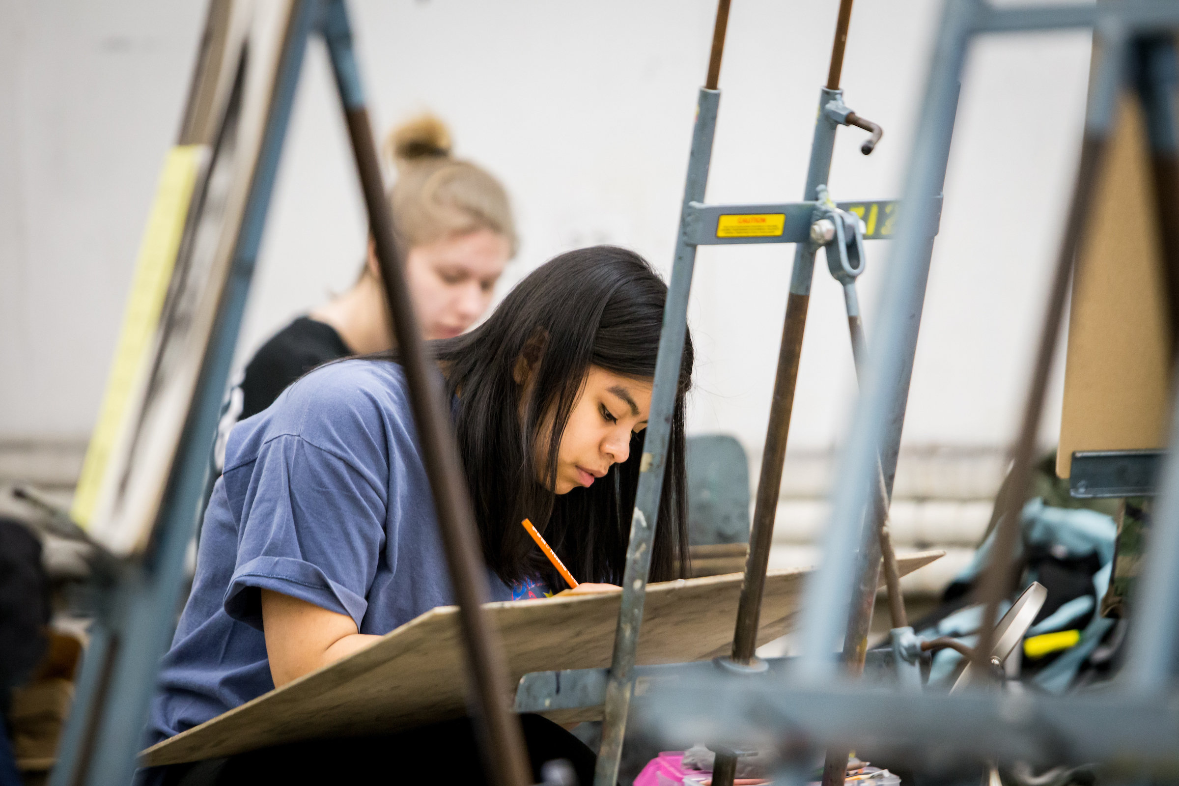 Photo of a VAC student working on a drawing.